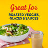 This image promotes a product that is great for roasted veggies, glazes, and sauces, featuring a salad and a jar of the product on a pink and white towel against a yellow background.