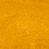 A close-up texture of a vibrant orange-yellow sauce with visible spice particles.