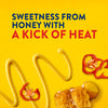 This image promotes a product with the tagline sweetness from honey with a kick of heat, featuring mustard, honeycomb, and red peppers.