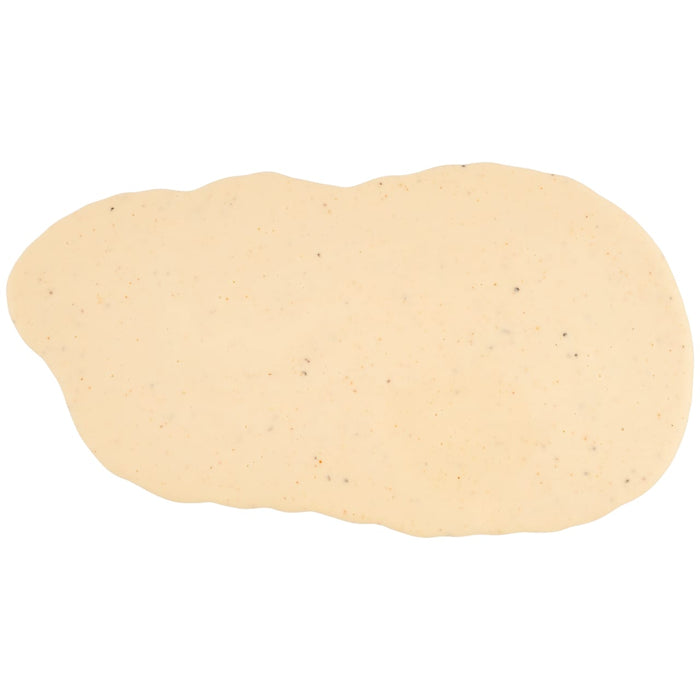 A creamy, off-white smear of Cattlemens Alabama White Oz is spread on a white surface, showing the texture and specks of seasoning.