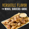 A plate of chicken wings coated in the creamy Cattlemen'S Alabama White Bbq Sauce, 0.5 Gal, is shown with the text Versatile flavor for wings, burgers &amp; more.