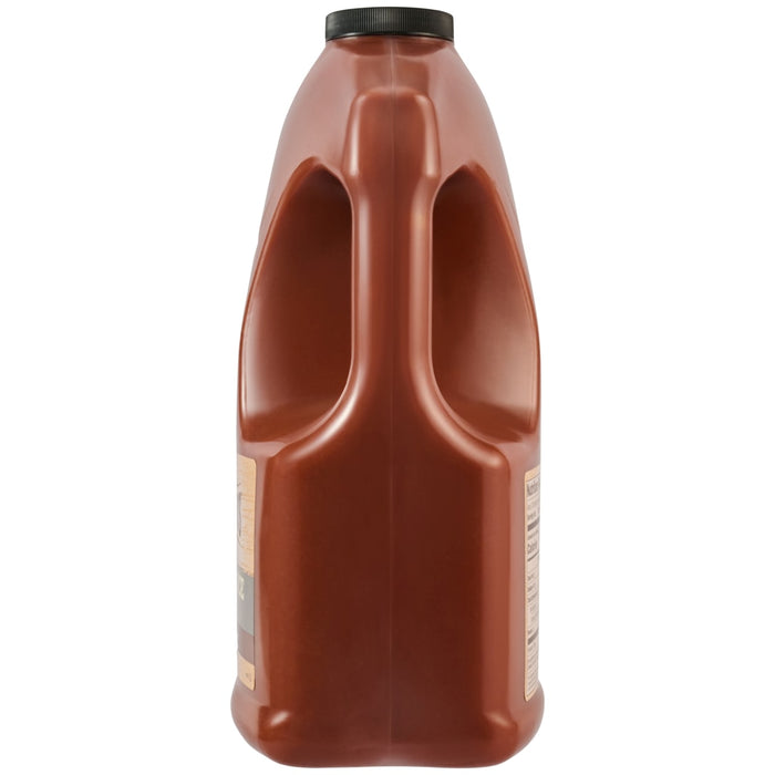 A side view of the Cattlemens Smoky Barbeque Sauce Plastic Jug 128 Oz shows the large, integrated handle.
