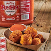 A gallon jug of Frank's RedHot Original hot sauce with a small container of the sauce and crispy fried cheese balls.