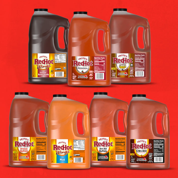 A collection of Frank's RedHot sauce bottles in different flavors.
