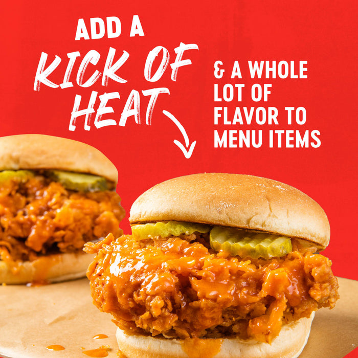A sandwich with fried chicken, pickles, and a spicy sauce, with the text 'Adds a kick of heat &amp; a whole lot of flavor to favorite foods' on a red background.