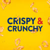 ['Crispy &amp; Crunchy text in blue with an ampersand in red, surrounded by onion rings.']