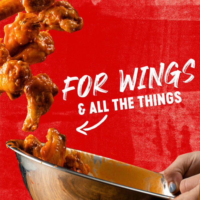 ["Chicken wings are being tossed in a bowl with the text 'For Wings &amp; All The Things' on a red background."]