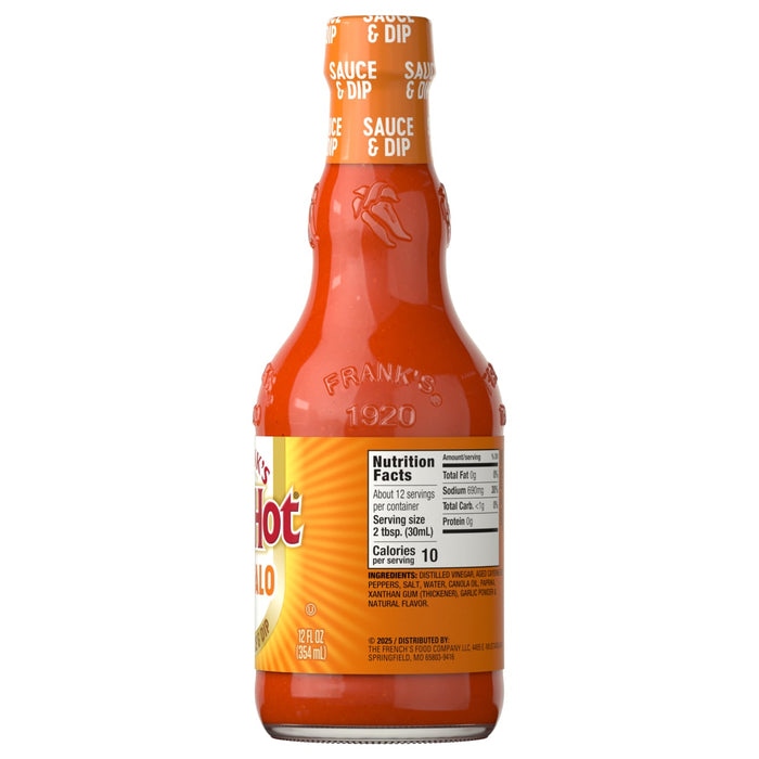 The back of a glass bottle of Franks Red Hot Buffalo Wing Hot Sauce Red Hot 12 Oz is shown, displaying the nutrition facts and ingredients list.
