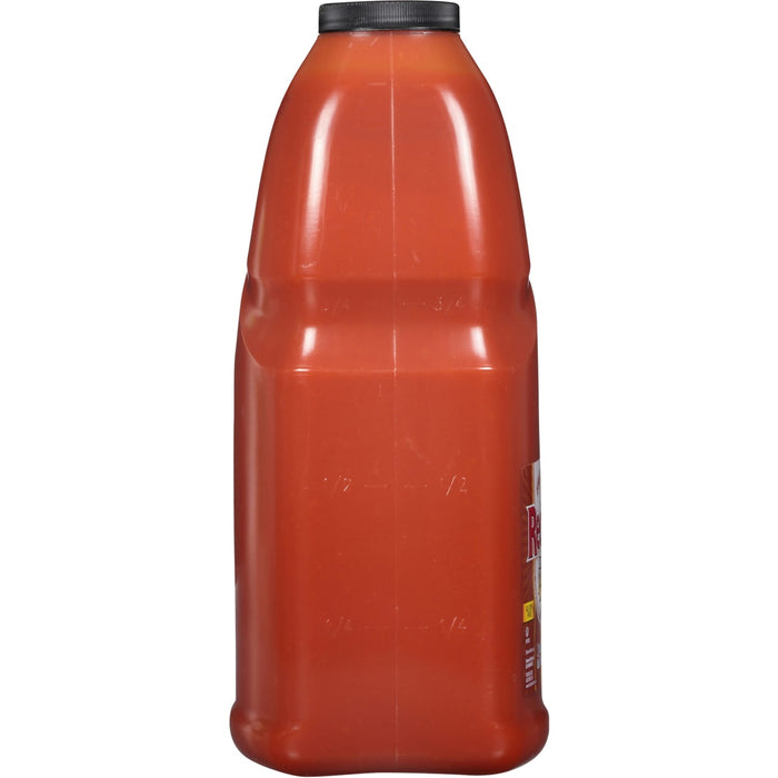 ['A red plastic bottle of Red Gold Tomato Sauce.']