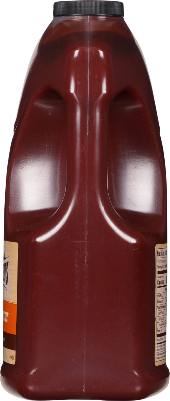 ["A large plastic bottle of Sweet Baby Ray's barbecue sauce."]