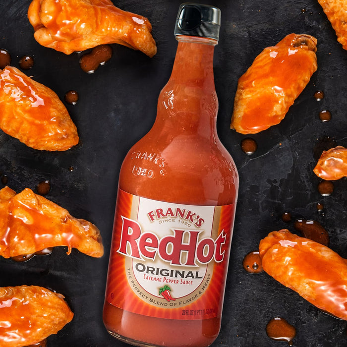 A bottle of Frank's RedHot Original Cayenne Pepper Sauce with chicken wings.