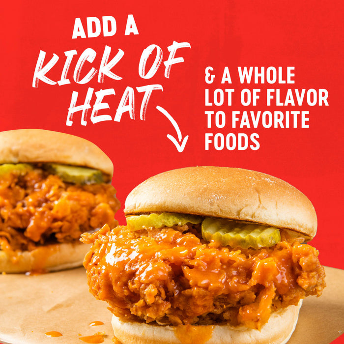 A sandwich with fried chicken, pickles, and a spicy sauce, with text that says Adds a kick of heat &amp; a whole lot of flavor to favorite foods.