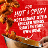 ['A bowl of hot and spicy chicken wings with the text For Hot &amp; Spicy Restaurant-Style Chicken Wings Right In Your Own Home on a red background.']