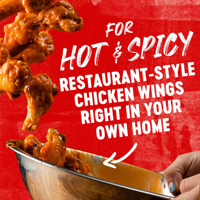 ['A bowl of hot and spicy chicken wings with the text For Hot &amp; Spicy Restaurant-Style Chicken Wings Right In Your Own Home on a red background.']
