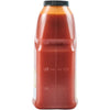 ['A plastic bottle with a black lid filled with red liquid and markings for 1/4, 1/2, and 3/4.']