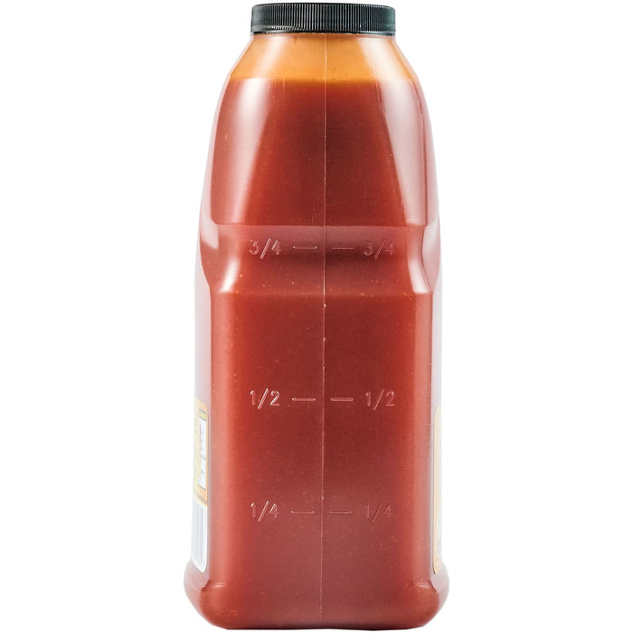 ['A plastic bottle with a black lid filled with red liquid and markings for 1/4, 1/2, and 3/4.']