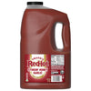 A one-gallon jug of Franks Red Hot Garlic Regular Hot Sauce Regular 128 Oz, with a red label identifying the flavor as Stingin' Honey Garlic Wing Sauce &amp; Dip.