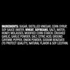 The ingredients list for Franks Red Hot Garlic Regular Hot Sauce Regular 128 Oz, shown in white text on a black background, includes sugar, distilled vinegar, and corn syrup.