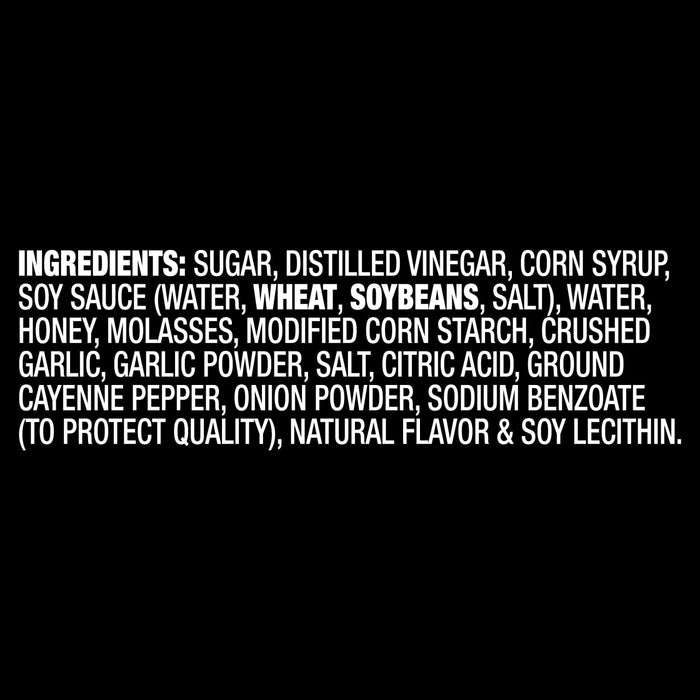 The ingredients list for Franks Red Hot Garlic Regular Hot Sauce Regular 128 Oz, shown in white text on a black background, includes sugar, distilled vinegar, and corn syrup.