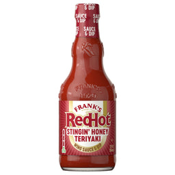 A glass bottle of Franks Red Hot Stingin Honey Teriyaki Wing Hot Sauce Mild 12 Oz is shown against a white background.