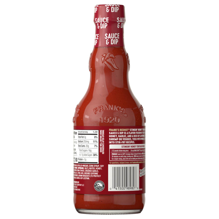 The back of a glass bottle of Franks Red Hot Stingin Honey Teriyaki Wing Hot Sauce Mild 12 Oz is shown, detailing the nutrition facts, ingredients, and a recipe for Stingin' Honey Teriyaki Wings.