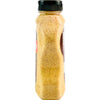 A bottle of Dijon mustard with visible mustard seeds.