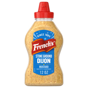 A clear squeeze bottle of Frenchs Beige Stone Ground Dijon Mustard 12 Oz featuring a blue and red label that highlights its chardonnay infusion and heritage since 1904.