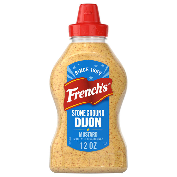 A clear squeeze bottle of Frenchs Beige Stone Ground Dijon Mustard 12 Oz featuring a blue and red label that highlights its chardonnay infusion and heritage since 1904.