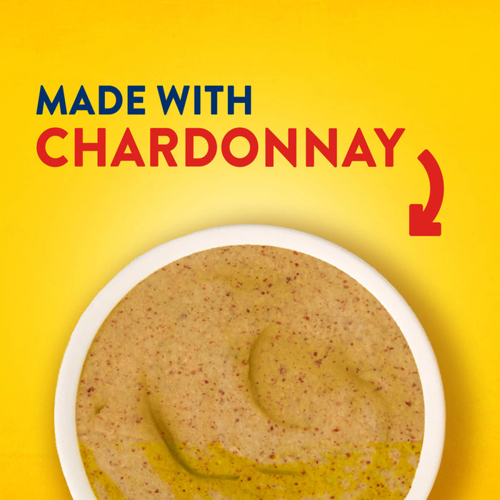 A top down view of a bowl filled with Frenchs Beige Stone Ground Dijon Mustard 12 Oz against a bright yellow background with text stating it is made with Chardonnay.