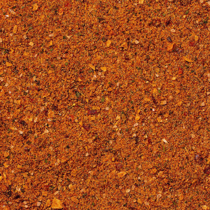 A close up view shows the vibrant and textured blend of spices that make up the Cholula Medium Taco Seasoning Mix 1 Oz.