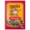 A 28 gram packet of Cholula Medium Taco Seasoning Mix 1 Oz featuring the iconic brand logo and an illustration of a woman preparing fresh ingredients above a photo of two street tacos.