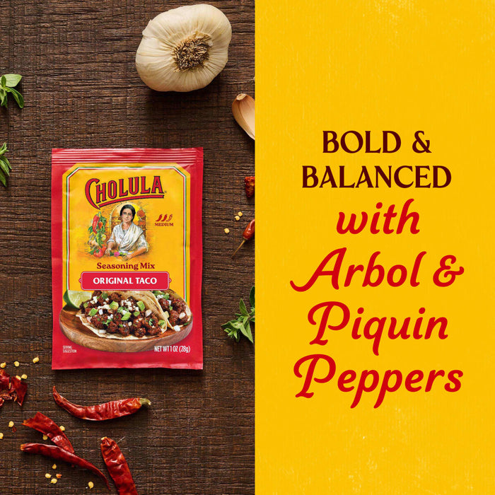 A packet of Cholula Medium Taco Seasoning Mix 1 Oz is displayed on a rustic wooden surface alongside fresh garlic and dried peppers to highlight its bold and balanced flavor profile.