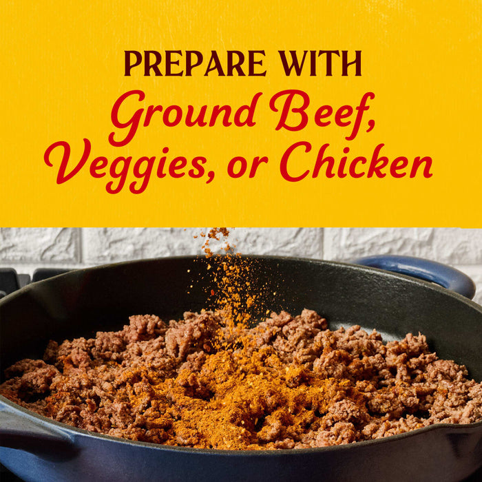 A skillet of browned ground beef is being seasoned with Cholula Medium Taco Seasoning Mix 1 Oz under text suggesting it can also be prepared with veggies or chicken.