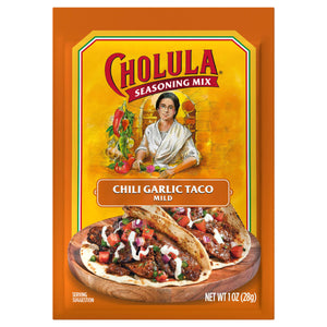 A package of Cholula Chili Garlic Taco Seasoning Mix, with a serving suggestion of tacos on a wooden plate.