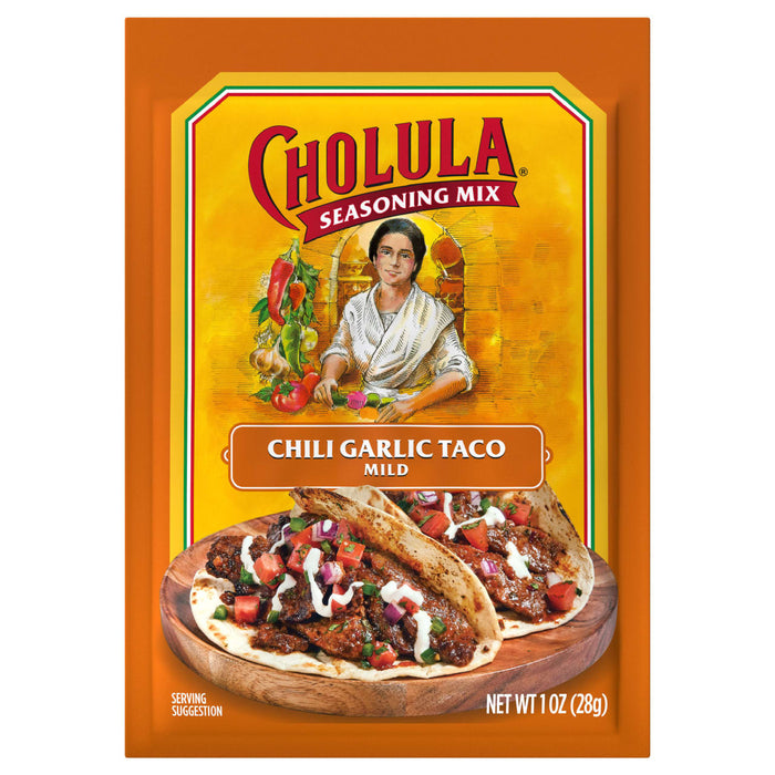 A package of Cholula Chili Garlic Taco Seasoning Mix, with a serving suggestion of tacos on a wooden plate.