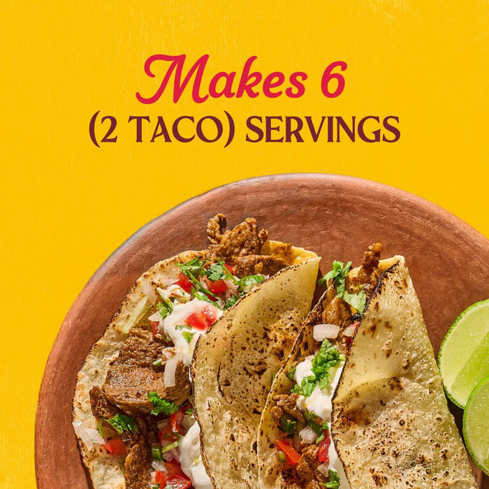 A close up of three steak tacos prepared with Cholula Medium Chili Garlic Taco Seasoning Mix 1 Oz on a clay plate against a yellow background with text stating it makes six two taco servings.