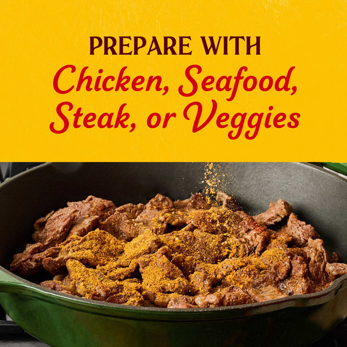 A skillet filled with strips of steak being seasoned with Cholula Medium Chili Garlic Taco Seasoning Mix 1 Oz under text that suggests preparing the meal with chicken, seafood, steak, or veggies.