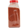 A clear plastic jar with a red lid filled with red chili powder.
