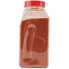 A clear plastic jar with a red lid filled with red chili powder.