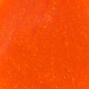 A close-up of a bright orange sauce with small white flecks.