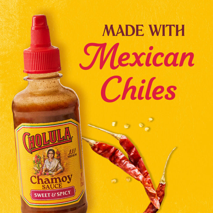 A bottle of Cholula Chamoy Sauce is displayed with dried chiles and the text "Made with Mexican Chiles" on a yellow background.