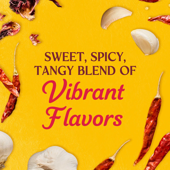 A vibrant blend of sweet, spicy, and tangy flavors is showcased with garlic cloves, dried chili peppers, and hibiscus flowers scattered on a yellow background.