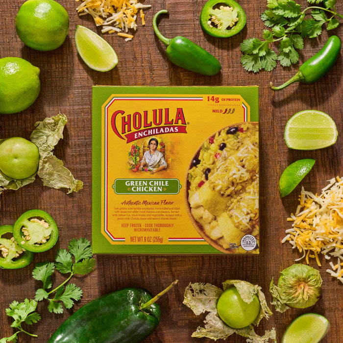 A Cholula brand frozen quesadilla meal is displayed amidst fresh ingredients like limes, jalapeA?os, and cilantro, suggesting a flavorful and spicy culinary experience.