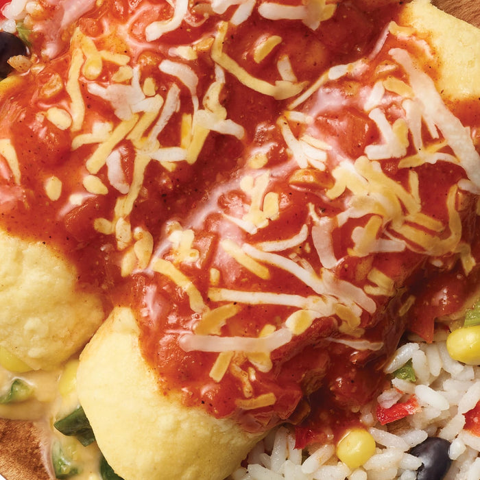 A close-up shot of enchiladas covered in red sauce and shredded cheese served with rice and beans showcasing a delicious and appetizing meal.