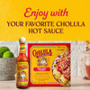 A Cholula hot sauce bottle and a Cholula enchilada dinner kit are displayed with limes, promoting the brands products.