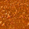 A close-up shot of a vibrant, chunky salsa with visible pieces of tomato, onion, and herbs.