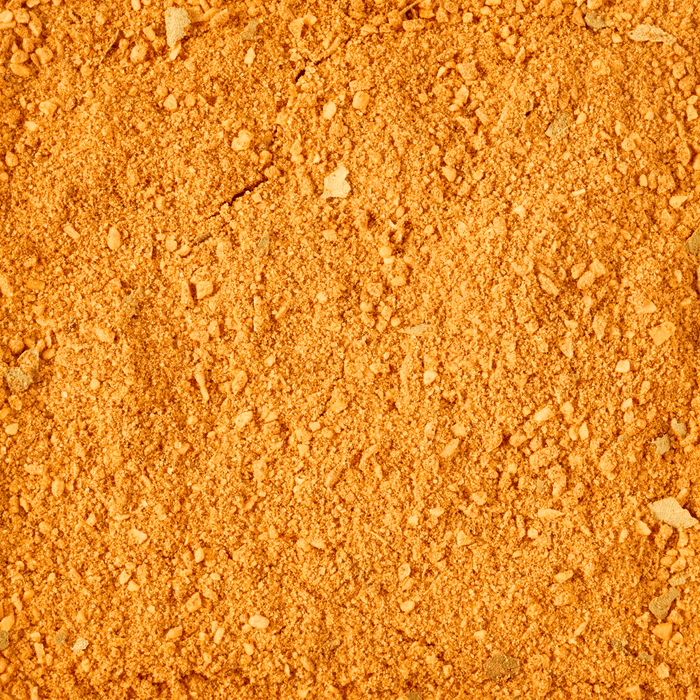 A close-up of reddish-brown dirt or soil texture.
