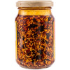 A jar of chili oil with sunflower, ricotta, and pumpkin seeds.