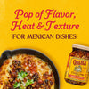 A jar of Cholula Chili Crisp Sauce is featured next to a skillet of cheesy Mexican dip with the text Pop of Flavor Heat &amp; Texture for Mexican Dishes above.