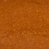 A textured reddish-brown surface with small scattered particles creates a warm and earthy visual.